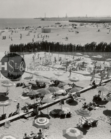Sunbathers on the beach at the Pacific Coast Club, c. 1960