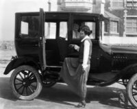 Vintage getting into car sunny day Historical society of long beach