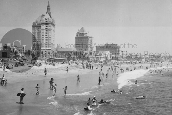 Long beach photograph of families having fun in the water